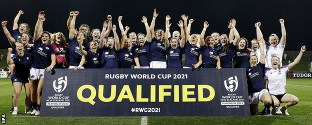Scotland celebrate in front of a sign reading 'qualified'
