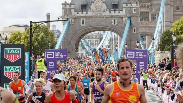 London Marathon runners cross Tower Bridge