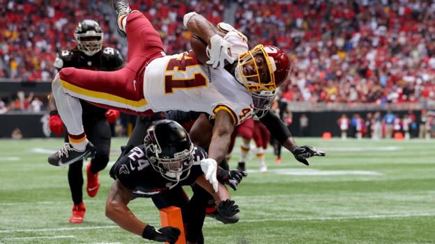  JD McKissic of the Washington Football Team dives for a touchdown while tackled by AJ Terrell of the Atlanta Falcons during the fourth quarter at Mercedes-Benz Stadium in Atlanta, Georgia