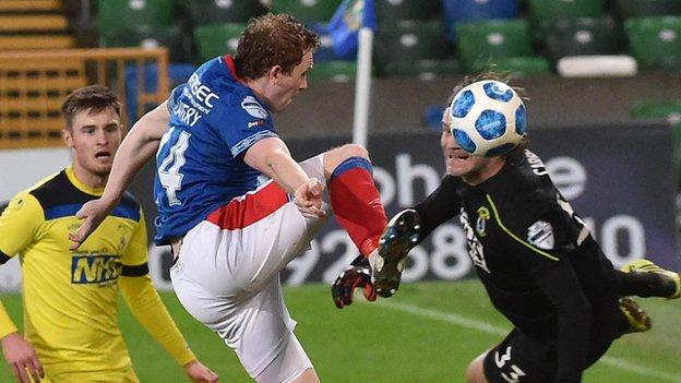 A battle for the ball between Linfield striker Shane Lavery and Swifts stopper Roy Carroll