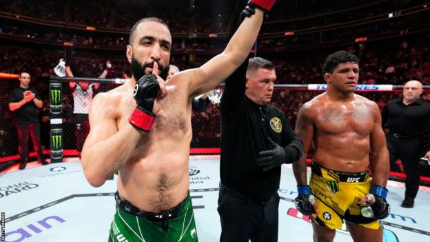 Belal Muhammad raises his arm after beating Gilbert Burns