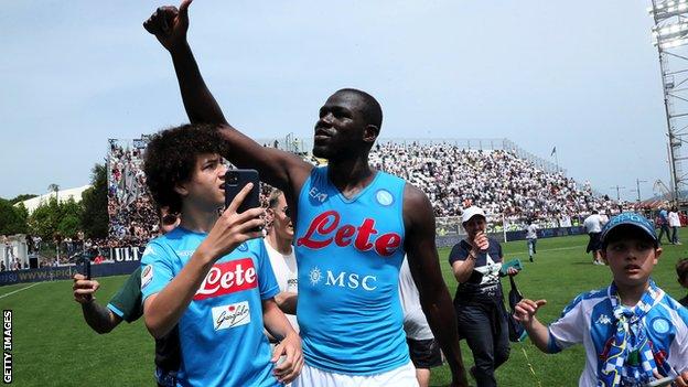 Kalidou Koulibaly greets Napoli fans after a win at Spezia