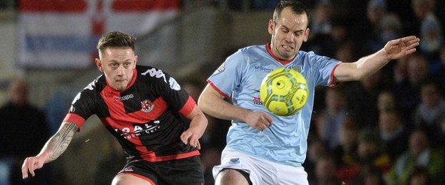 Matthew Snoddy of Crusaders in action against Ballymena's Tony Kane