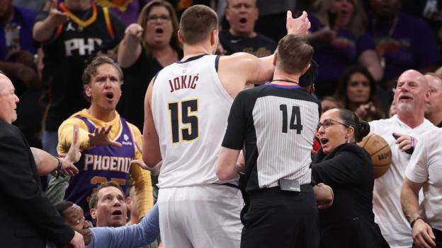 Fans shouting at Nikola Jokic after he pushed Phoenix Suns owner Mat Ishbia back into his seat