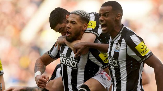 Joelinton celebrates with team-mates after Newcastle score in the FA Cup