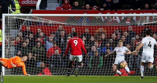 Ben Mee clears Marcus Rashford's shot off the line