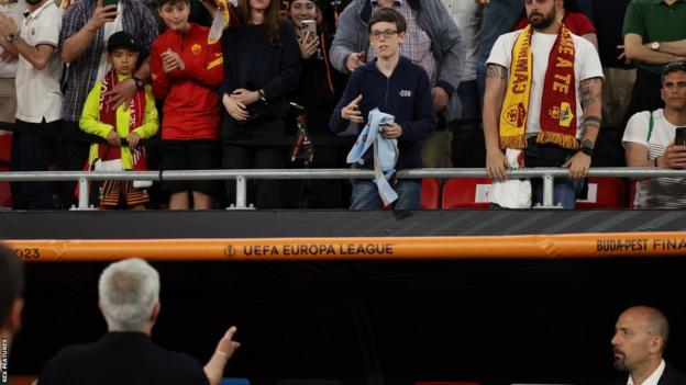 Roma manager Jose Mourinho passed his runners-up medal to someone in the crowd