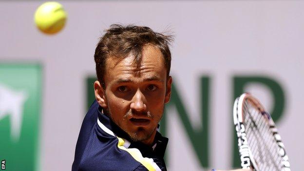 Daniil Medvedev returns at the French Open