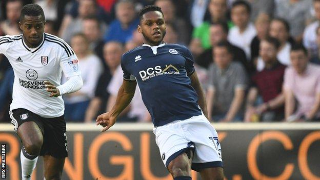 Mahlon Romeo of Millwall is pursued by Fulham winger Ryan Sessegnon