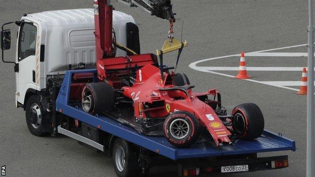 Sebastian Vettel's Ferrari is towed away