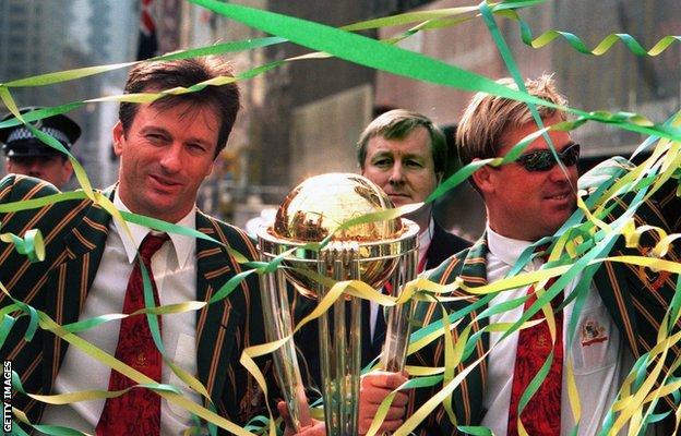 Australian cricket captain Steve Waugh, left, and bowler Shane Warne wave to fans in Sydney during a tickertape parade celebrating the Australian cricket team's World Cup win, 28 June 1999