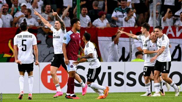 Pawel Wszolek (arms raised) celebrates giving Legia Warsaw a third-minute lead over Aston Villa