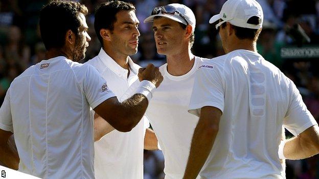 Jean-Julien Rojer of the Netherlands, left, and Horia Tecau of Romania, second left, win the men's doubles final against Jamie Murray of Britain and John Peers of Australia