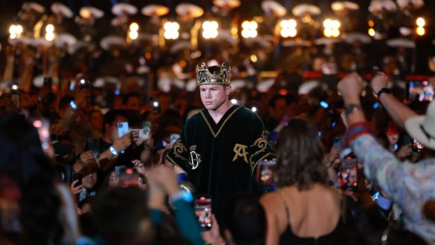 Saul 'Canelo' Alvarez wears a crown on his head as he makes his ring walk