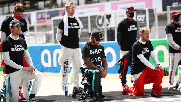 Drivers kneel or stand during the anti-racism protest