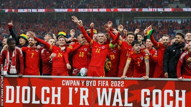 Wales players celebrate reaching the World Cup