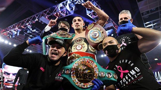 Teofimo Lopez celebrates with his IBF, WBO and WBA (Super) titles with his team