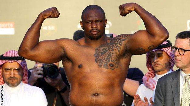 Dillian Whyte poses at a weigh-in
