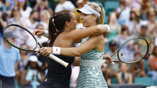 Katie Boulter and Jodie Burrage embrace at the net