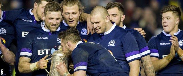 Scotland's Ryan Wilson kisses the trophy at full time