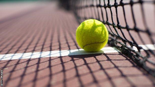 Tennis ball lying on the court