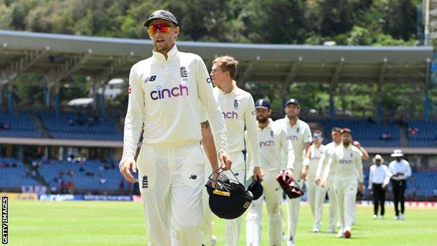 Joe Root leads England out