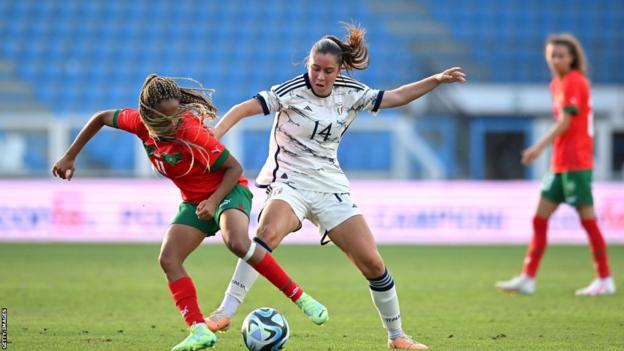Italy's Giulia Dragoni battles for possession with Morocco's Fatima Tagnaout during their friendly on 1 July