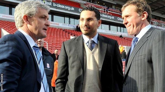 Khaldoon Al Mubarak (centre) speaks to former manager Mark Hughes (left) and former chief executive Garry Cook (right)