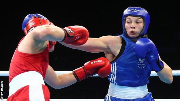 Boxer Lauren Price (right) aims a right hook at her opponent during a fight