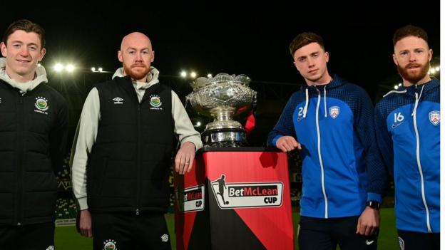 Linfield's Daniel Finlayson and Chris Shields and Coleraine's Matthew Shevlin and Lee Lynch with the League Cup