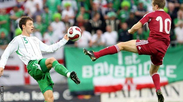 NI defender Jonny Evans challenges Latvia's Andrejs Rubins in the Euro 2008 qualifier in Riga