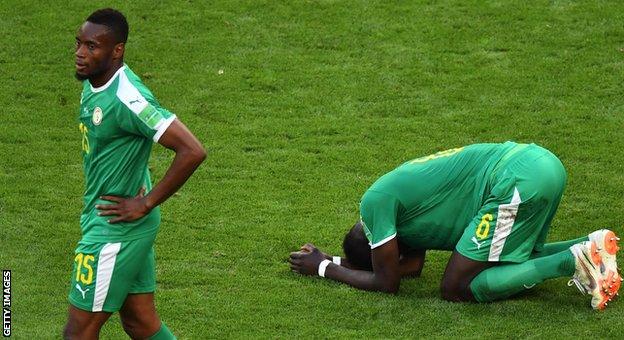 Senegal players Diafra Sakho and Salif Sane react after being eliminated from the 2018 World Cup