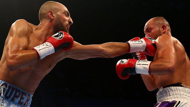 Evans in action against Bradley Skeete, in this image he is being punched in the face by a left jab