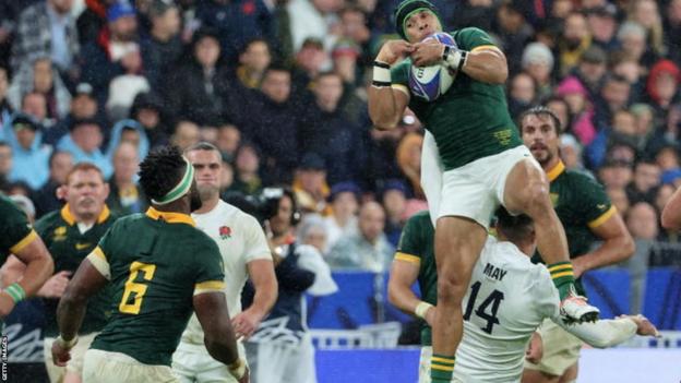 South Africa's Cheslin Kolbe leaps to catch the ball in the semi-final of the 2023 Rugby World Cup against England