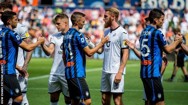 Oliver McBurnie of Swansea City shakes hands after the game against Atalanta