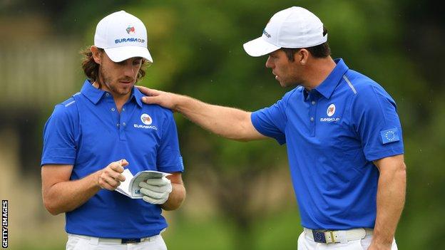 Tommy Fleetwood and Paul Casey talk during day one's fourballs at the EurAsia Cup in Malaysia