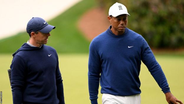Rory McIlroy and Tiger Woods share a conversation at the Masters.