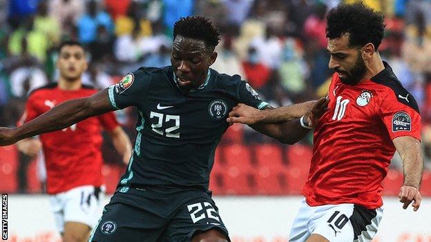 Egypt forward Mohamed Salah (right) fights for the ball with Nigeria's defender Kenneth Omeruo
