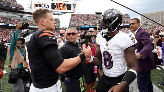 Joe Burrow of the Bengals shakes hands with Lamar Jackson of the Ravens