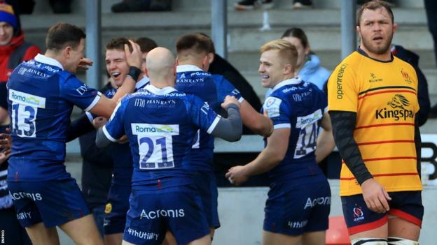Sale celebrate one of the six tries last month as Ulster's Duane Vermeulen looks dejected