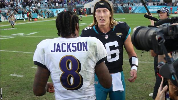 Trevor Lawrence shakes hands with Lamar Jackson
