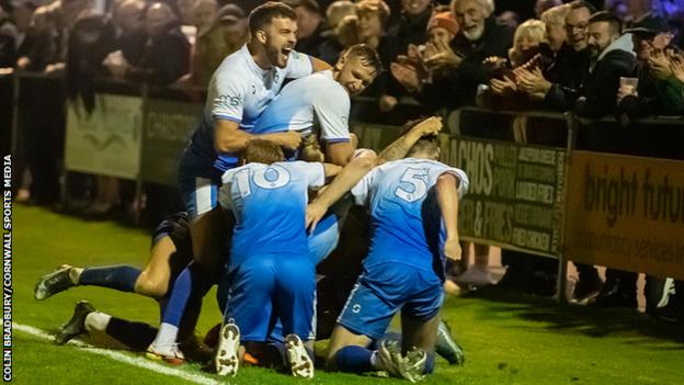 Helston's players celebrate scoring against Bishop's Cleeve in the FA Cup second qualifying round