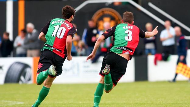 Fra McCaffrey goes in pursuit of Marcus Kane after the defender scored Glentoran's equaliser in their 1-1 draw at Carrick Rangers