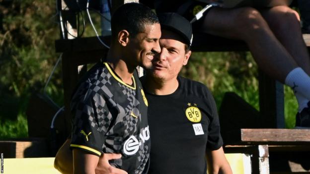 Borussia Dortmund head coach Edin Terzic with Sebastien Haller as the forward comes on against Fortuna Duesseldorf