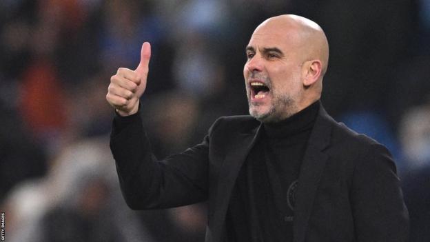 Pep Guardiola gives a thumbs up to his Manchester City players