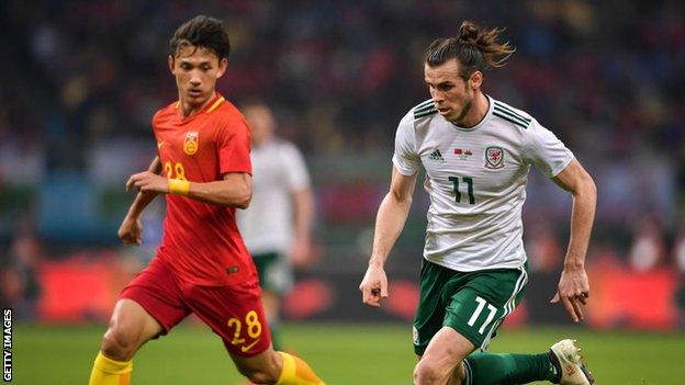 Gareth Bale takes on Wang Shenchao