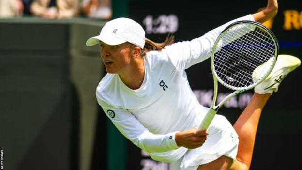 Iga Swiatek serves successful  her Wimbledon first-round match