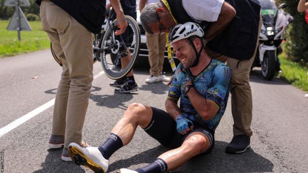 Mark Cavendish grimaces after a crash on stage eight of the 2023 Tour de France, which forced him to abandon the race