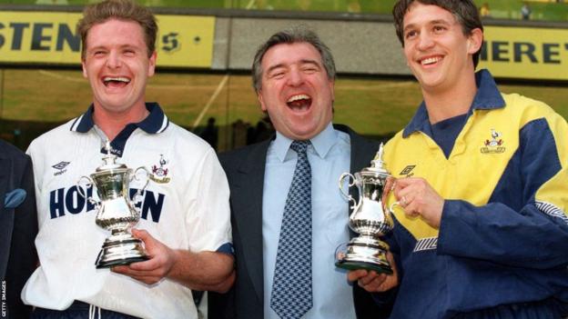 Paul Gascoigne and Gary Lineker laugh with then manager Terry Venables as they hold small replica FA Cup trophies