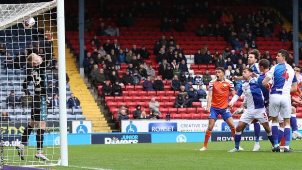 Swansea's Nathan Wood watches on as Ben Cabango's first-half header hits the bar